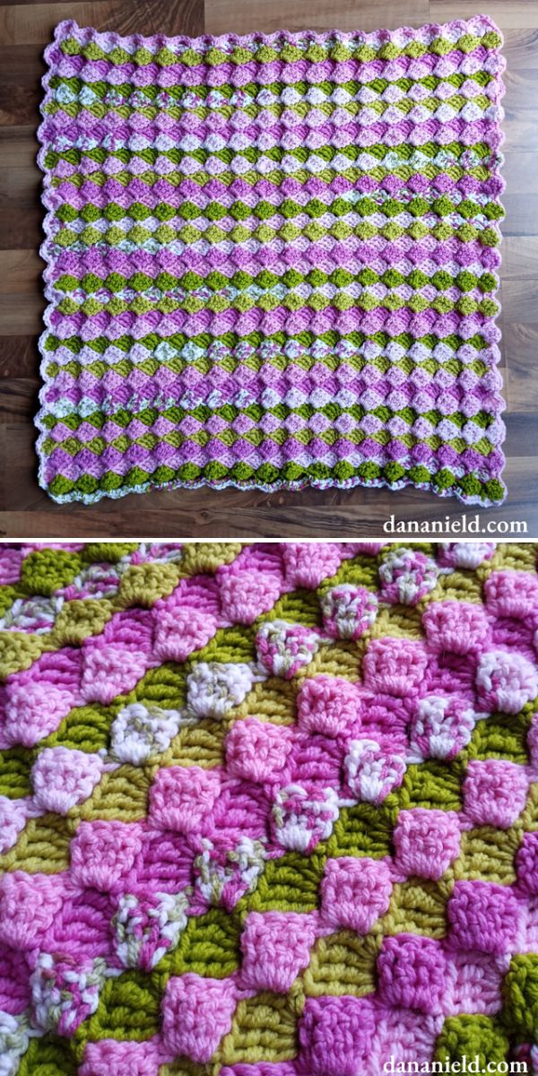 crochet shell stitch baby blanket in purples and greens