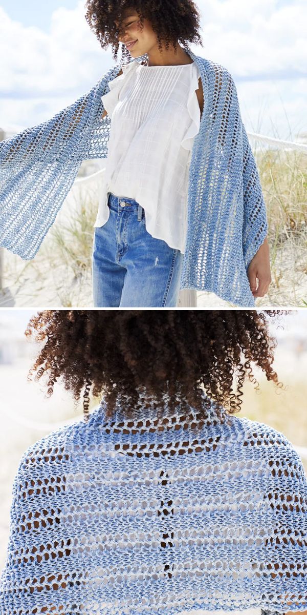 a woman on the beach in white top and blue crochet shawl
